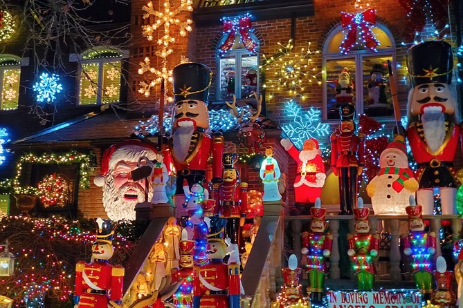 The front of a Dyker Heights house carrying nutcrackers, a Santa, snowmen and snowflake lights across every window